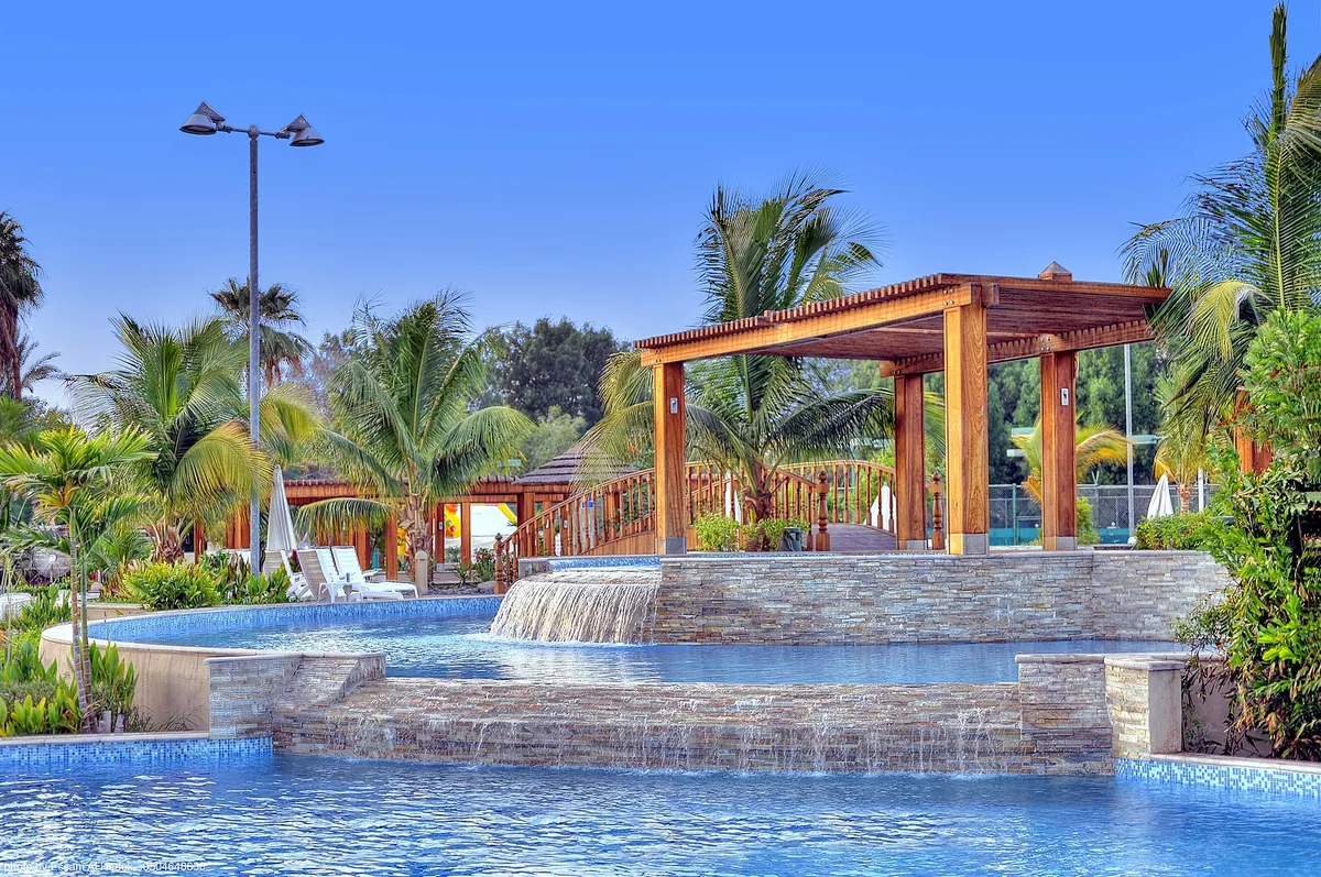 Poolside pergola and waterfall at Sharbatly Village